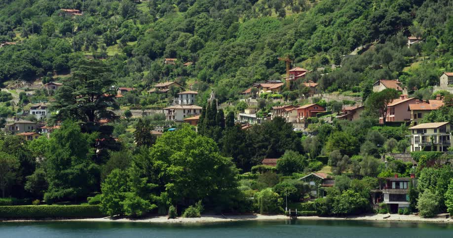 Homes and villas on a tree covered slope on lake como in italy
