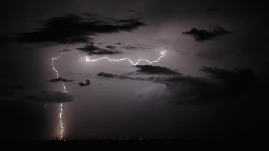 Lightning strikes through dark clouds