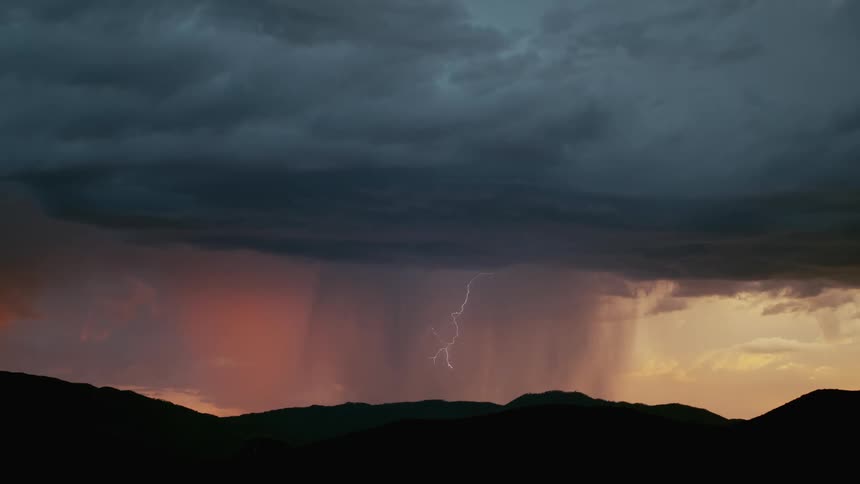 Lightning flashing across a sky with storm clouds