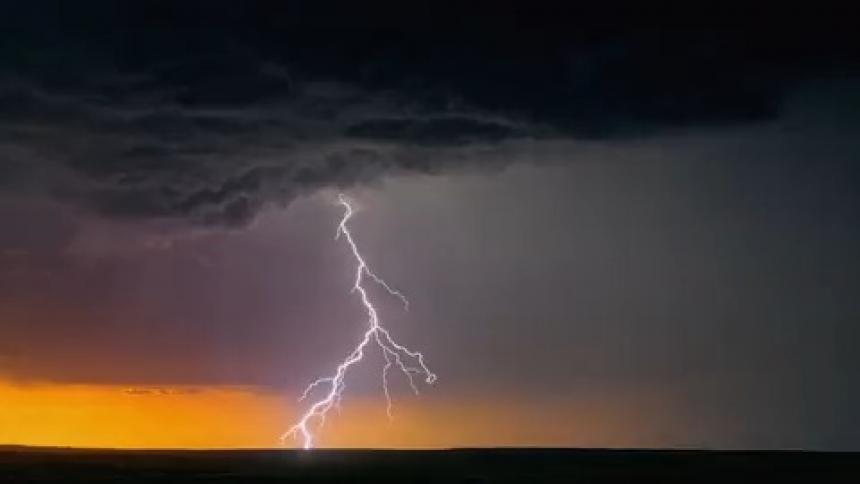 Large storm clouds pour rain and lightning