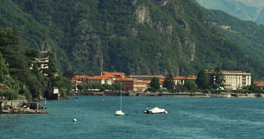 Coastal town in front of high green mountain
