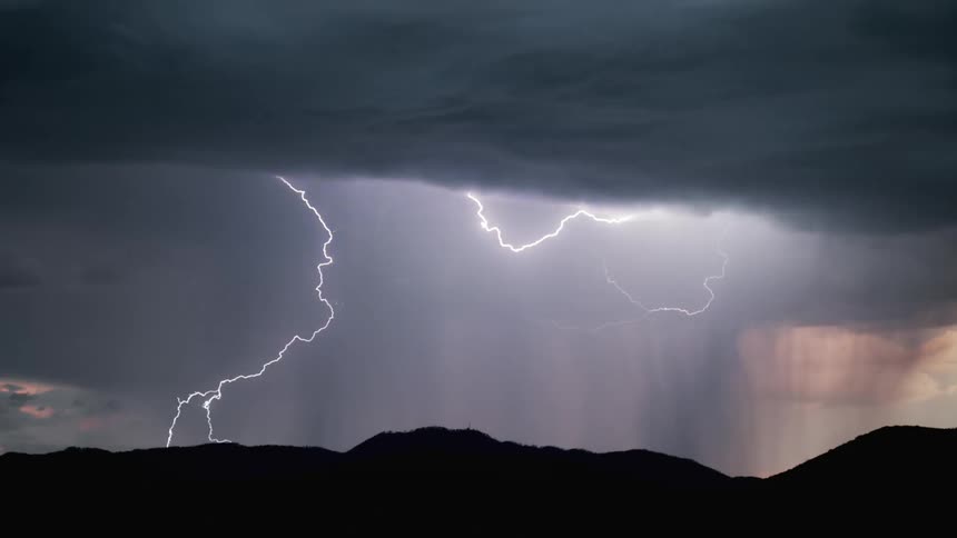 Lightning strikes over a mountain range