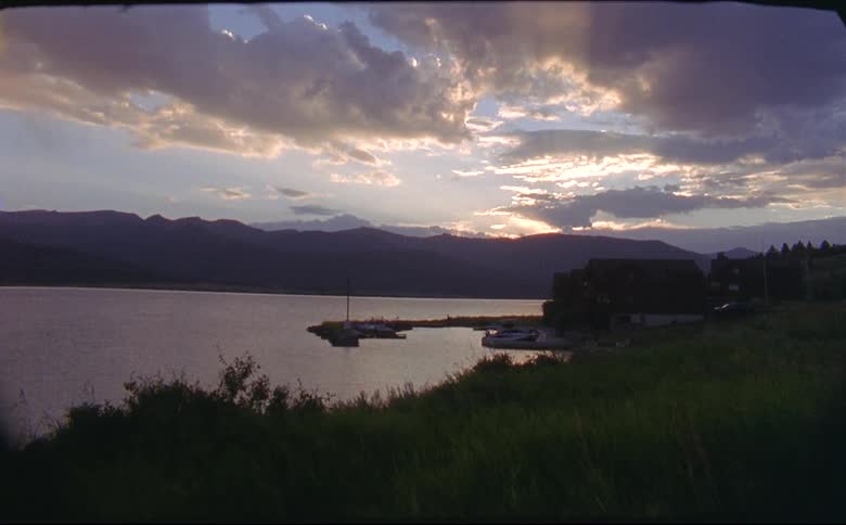A view of a cabin on a lake shot on 16mm film