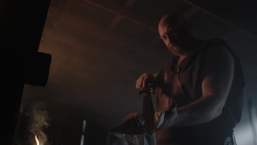 A man cleans his large knife