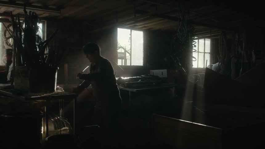 A woman organizing in a dark garage