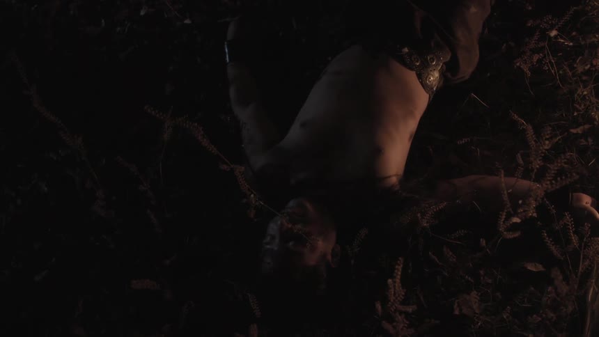 A man laying on the ground at night