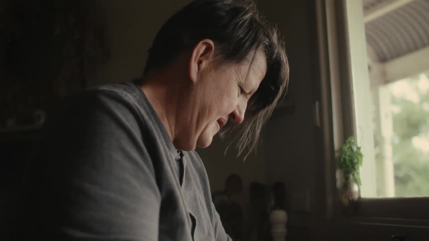 A woman washing at a kitchen sink