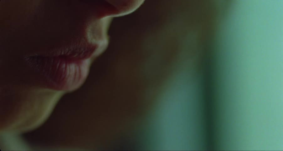 A woman puts a pill into her mouth