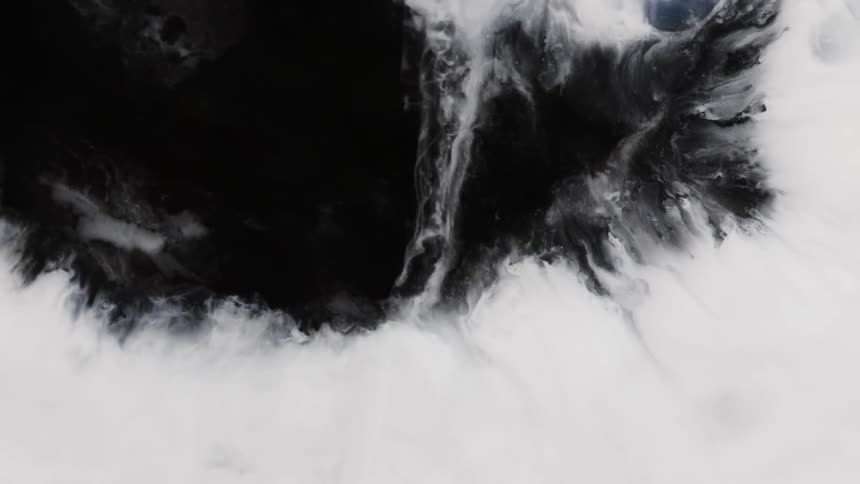 A wave of white rushes and flows to cover black