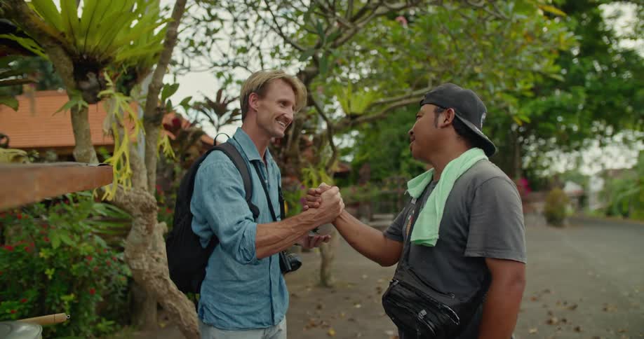 Tourist standing near a lush green garden has a taste of the local cuisine on vacation