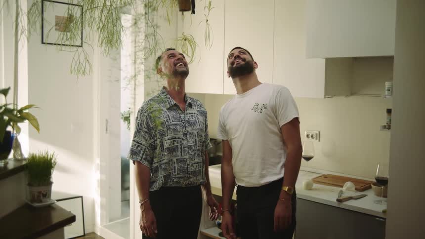 Two men looking at things in a room