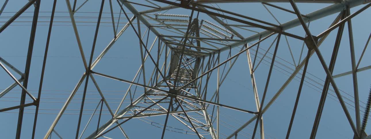Transmission tower against the blue sky