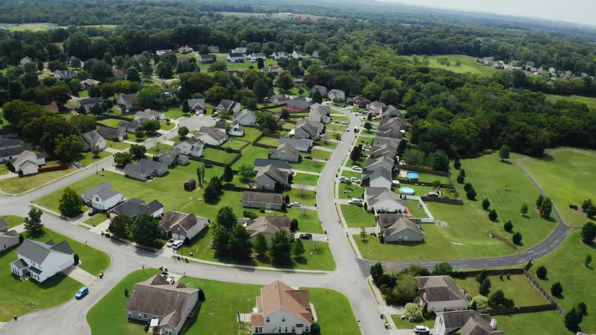An aerial view of cars and houses in a neighborhood