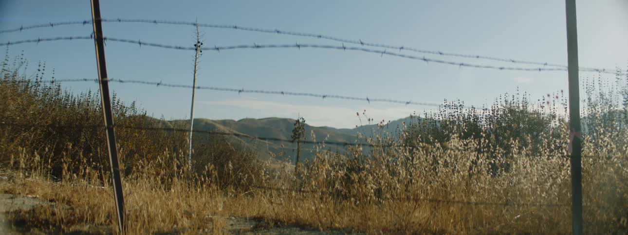 A barbed wire fence in a rural field