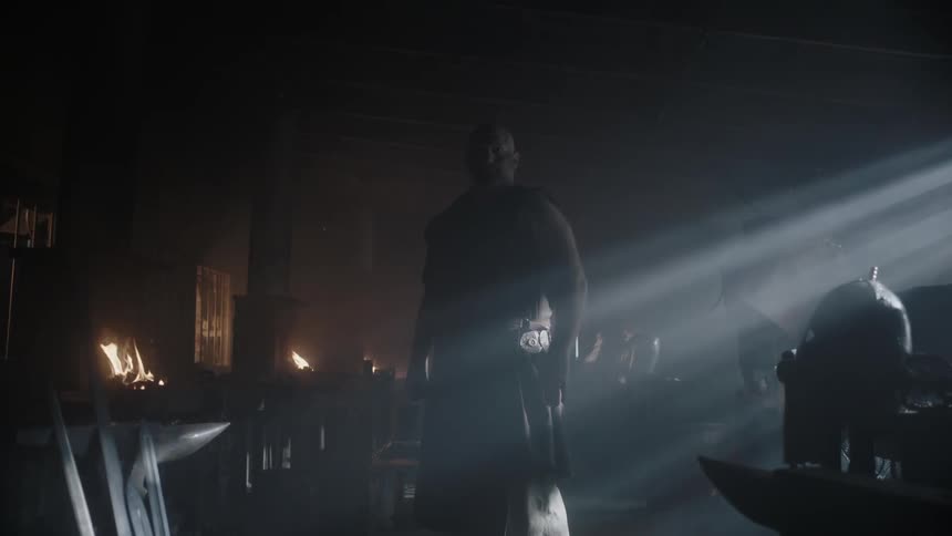 A warrior standing in a blacksmith shop