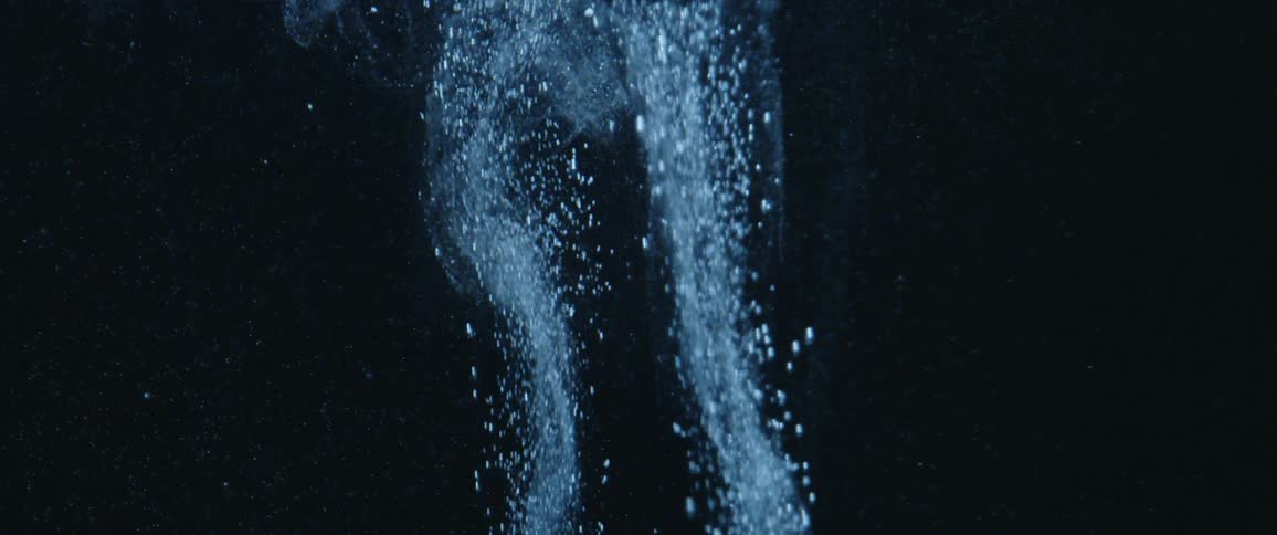 Abstract footage of bubbles rising in liquid
