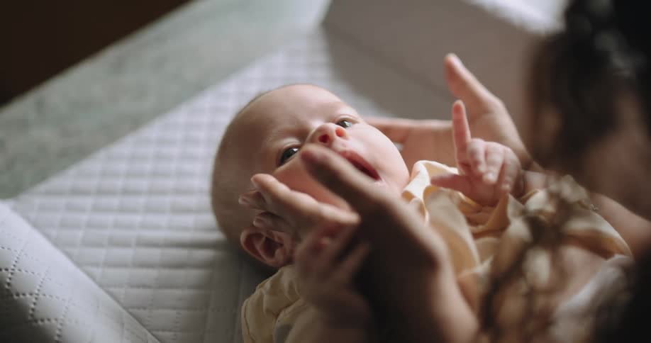 A mother holds her babys face