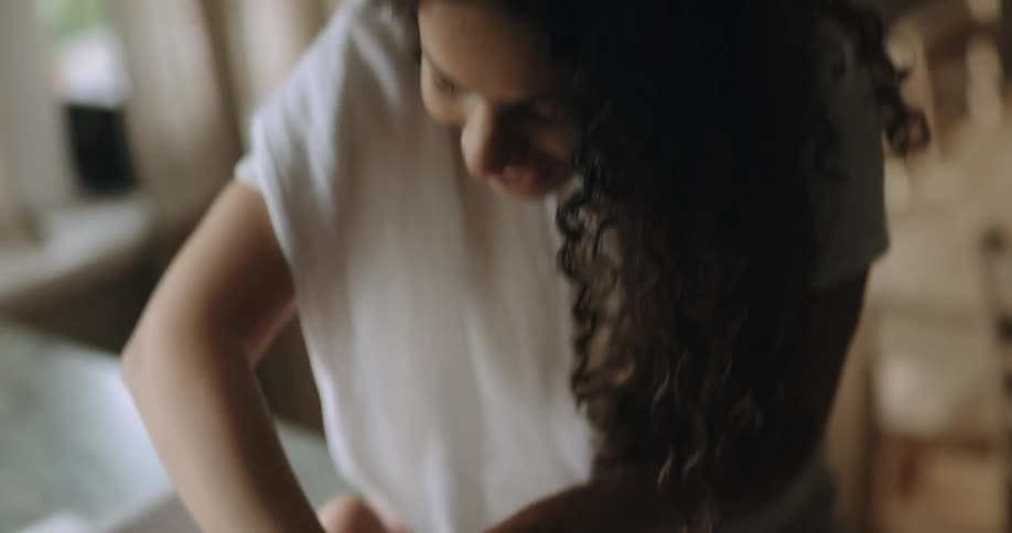 A woman changes her babys diaper as they move their arms and look around