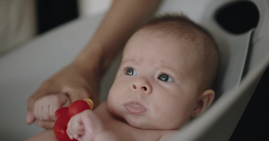 A mother giving her newborn baby a bath
