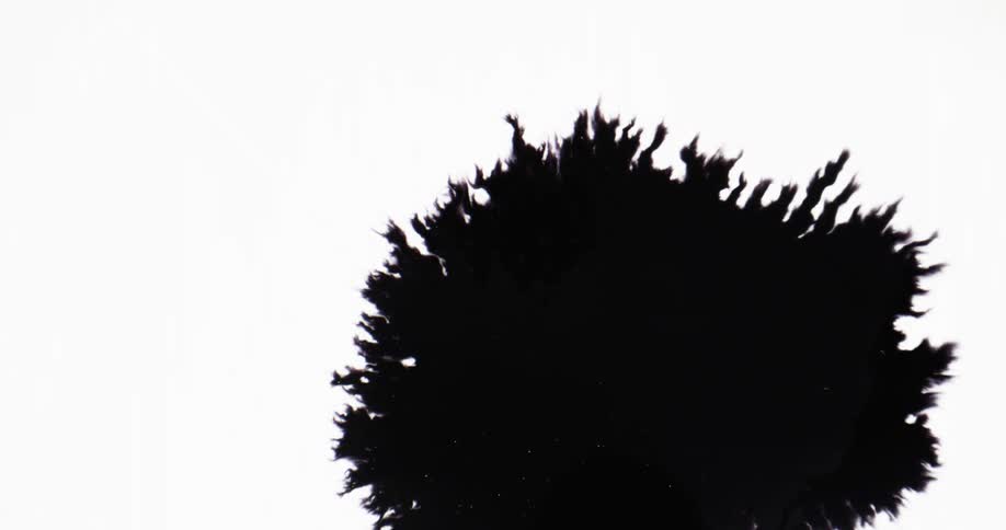 An ink spot grows larger as spikes form on the outer edge