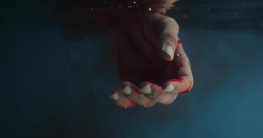 A bloody hand floating in water