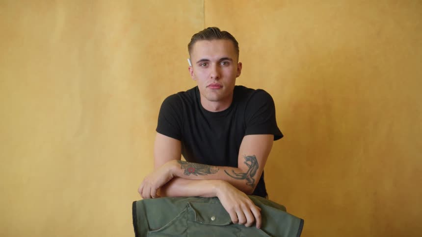 A portrait of a man sitting around