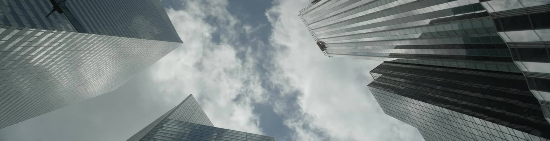 A view of a skyscraper from below on a cloudy day
