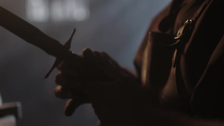 A person is examining a blade in his hand