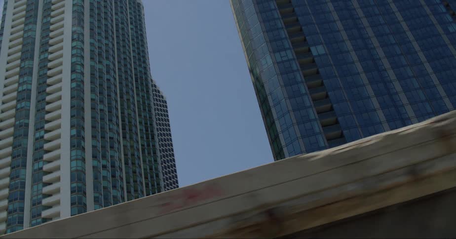 City skyscrapers against a bright blue sky from street level