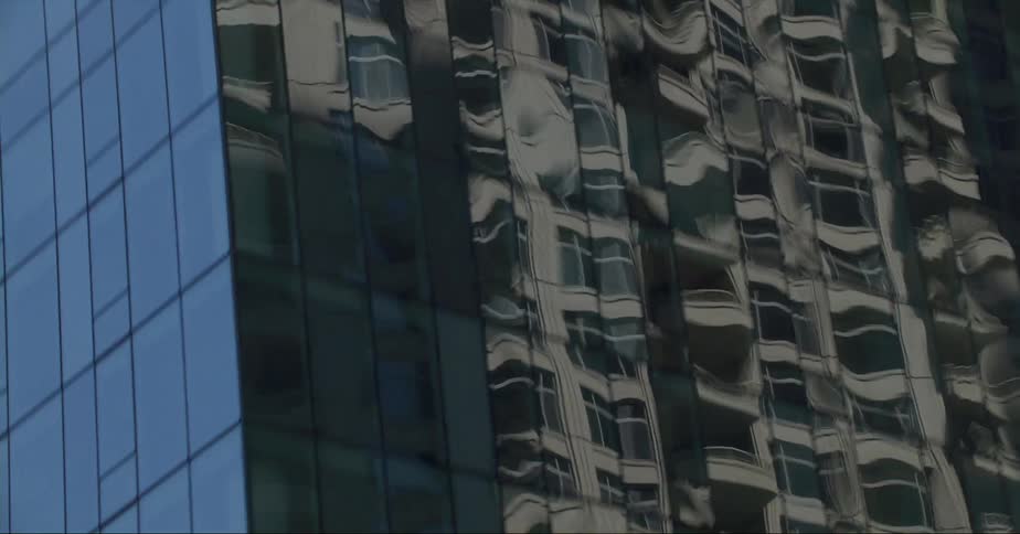 A reflective glass skyscraper in a city