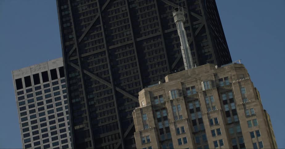 Chicago city skyscrapers and landmark buildings from street level against a bright blue sky