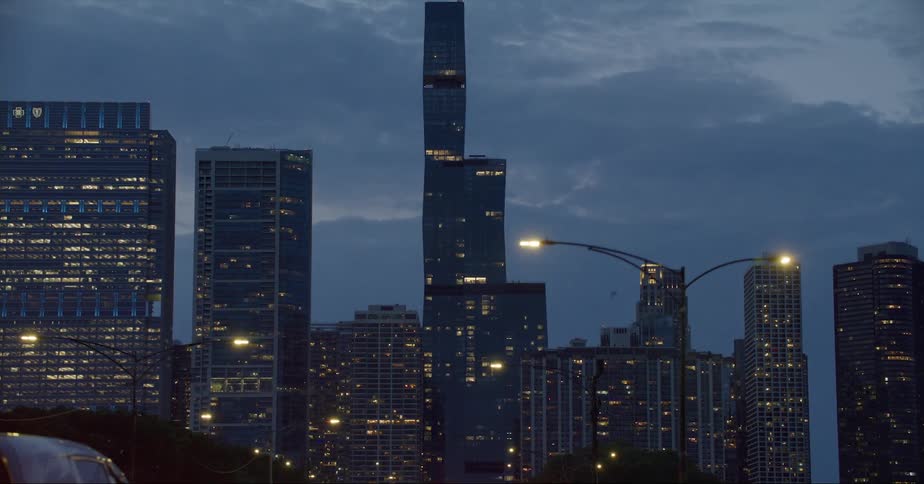 Traveling along a city street toward the chicago city skyline at dusk