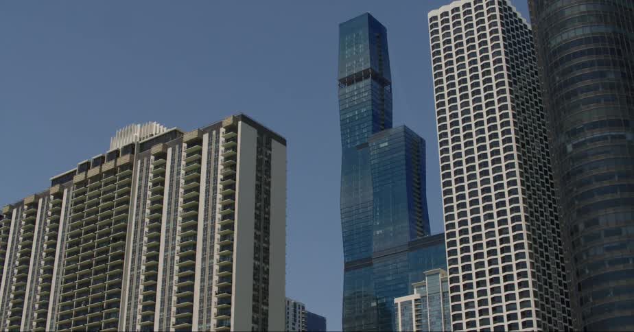 Towers and skyscrapers stand tall among other buildings on the city skyline