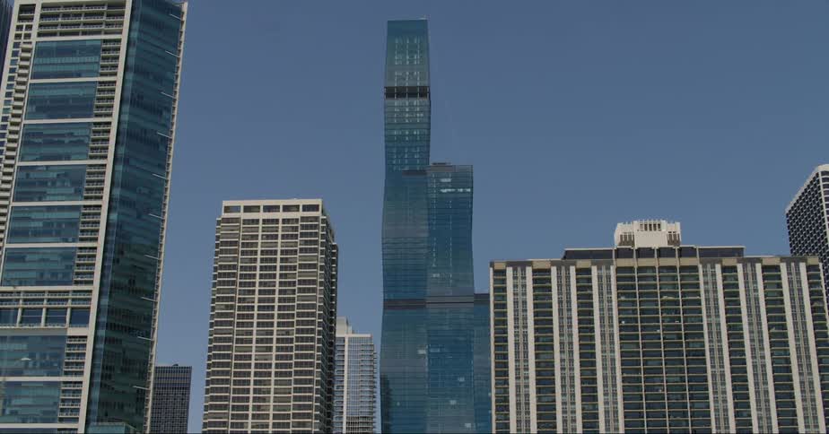 Exterior view of high rise buildings and office buildings against blue sky in the city
