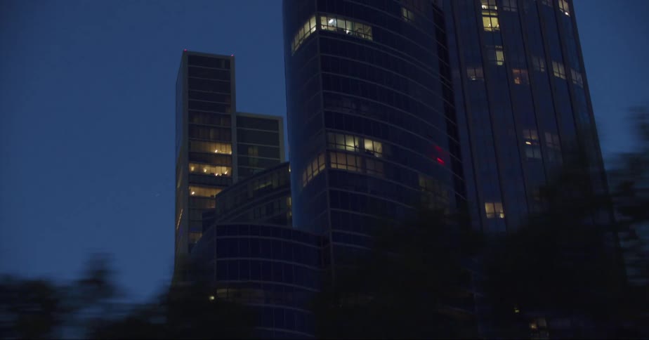 The sun is setting on the large building