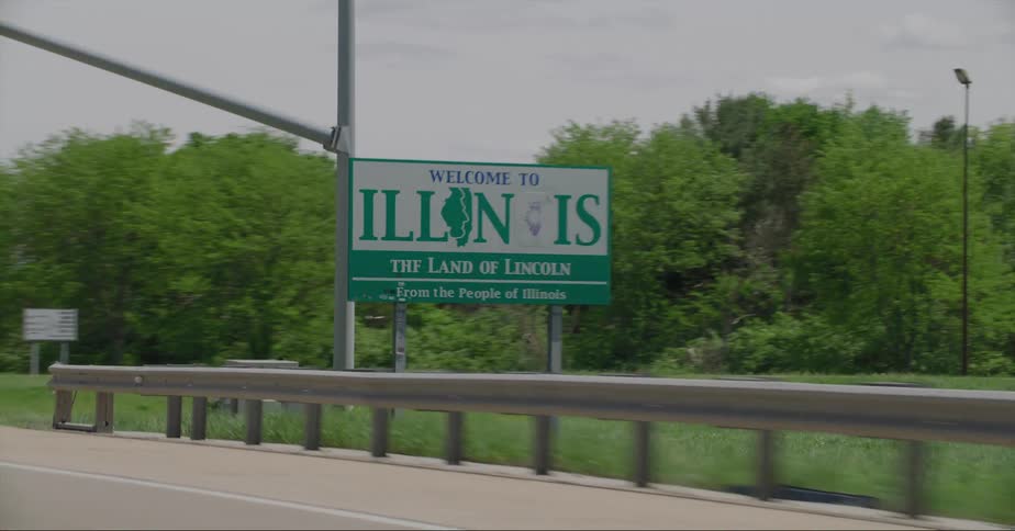 Red vehicle drives along highway and cross into illinois