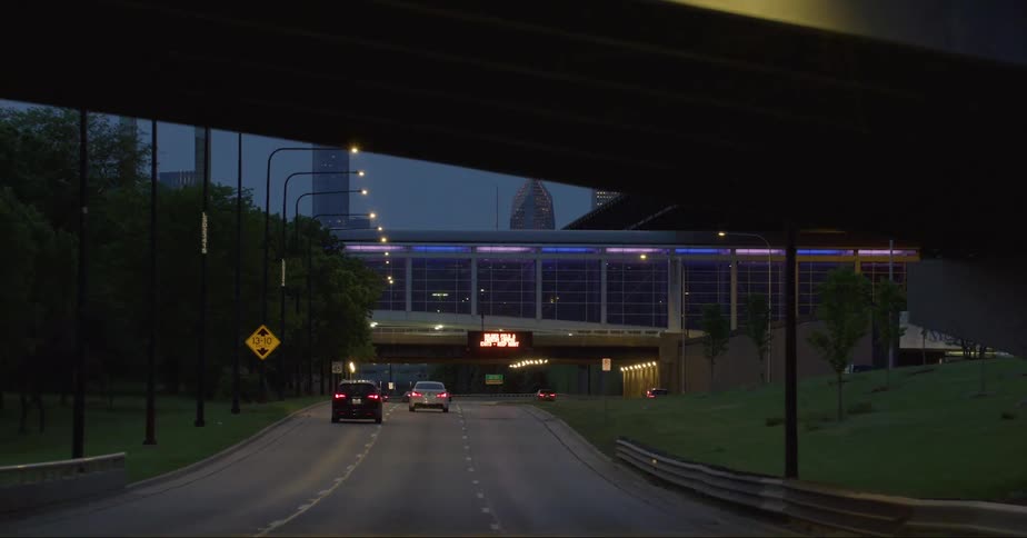 Vehicles drive on a highway headed toward downtown