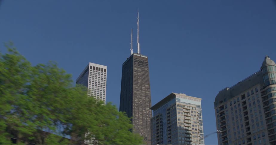 Downtown chicago buildings and skyscrapers from street level on a bright blue sky day