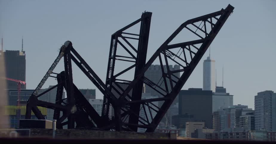 Distant skyscrapers drawbridge and high rise buildings seen from vehicle driving on highway