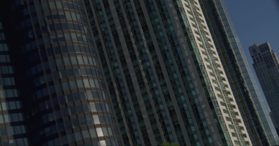Glass on downtown skyscrapers reflects bright sunshine