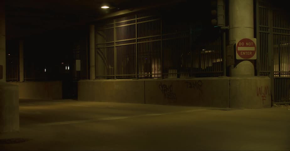 Entrance to a tunnel or subterranean parking garage in the city at night