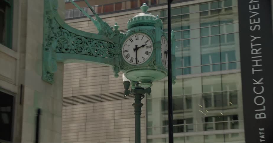 Building corner in downtown has multifaced clock attached