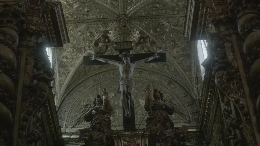 A church has a large cross with jesus on it