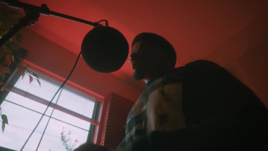 A man is rapping into the microphone
