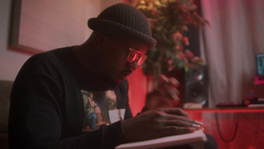 A man is writing notes in a notebook