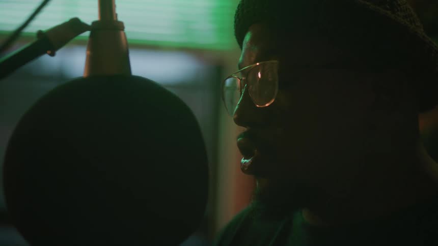 A man sings in to a microphone