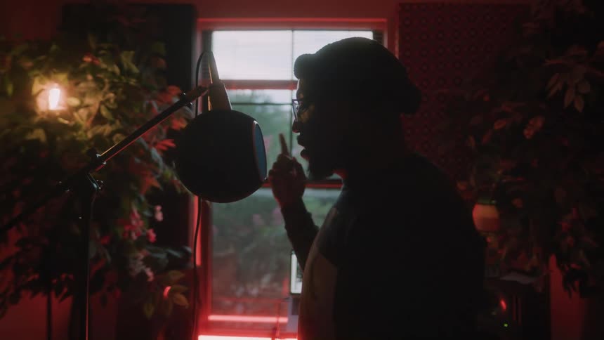 A man is rapping and moving his hands around