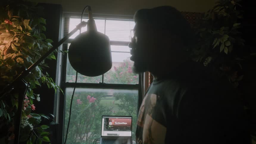 A man is rapping by the laptop