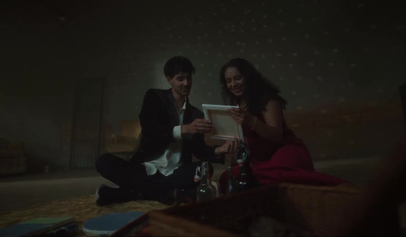 A man shows a picture to a woman