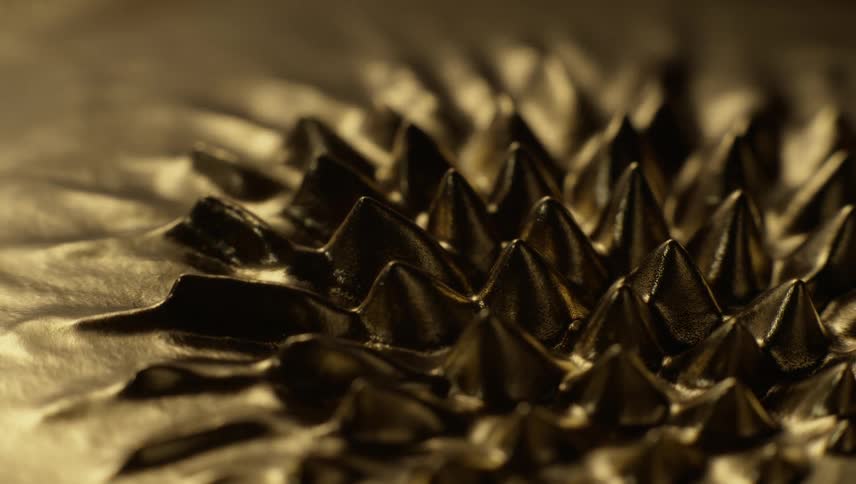 Spikes rise from a pool of liquid metal